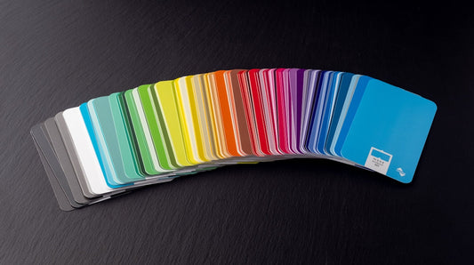 a stack of rainbow colored cards sitting on top of a table