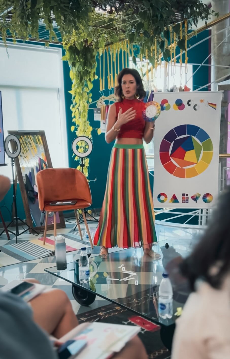 Sissa Germann teaching in front of a color wheel during an in-person class